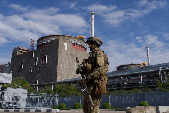A Russian service member patrols the Zaporizhzhia nuclear power plant.