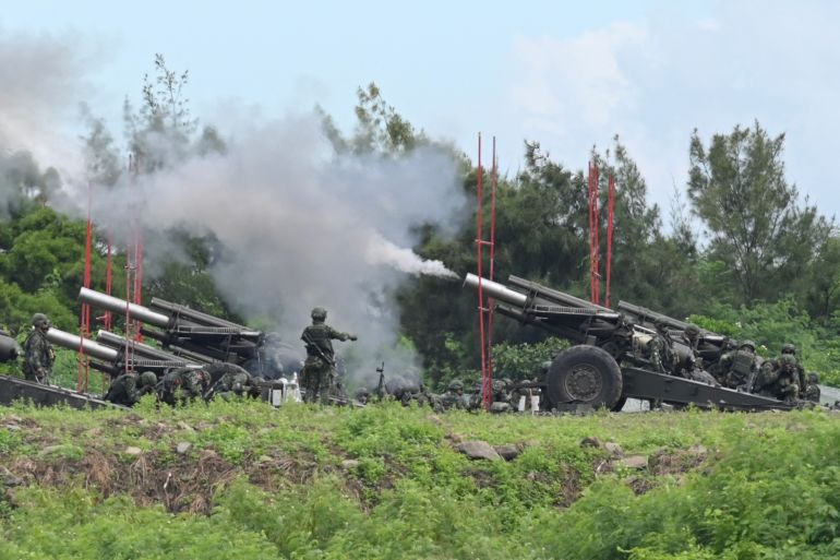 Taiwan military soldiers fire the 155-inch howitzers during a live fire anti landing drill in the Pingtung county, southern Taiwan on August 9, 2022.