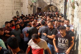 Palestinians evacuate an injured gunman