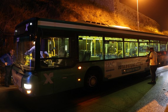 Israeli security inspect a bus after an attack outside Jerusalem's Old City, August 14, 2022