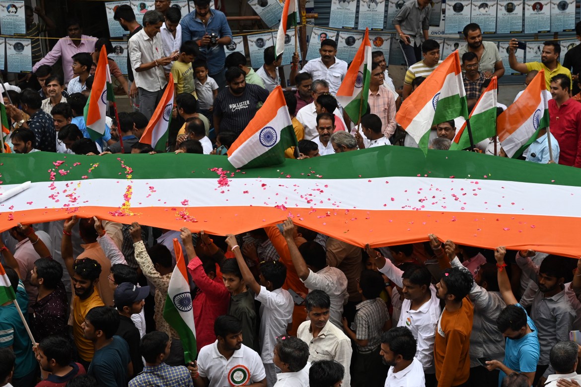 People carry the Indian national flag as they celebrate ahead of country