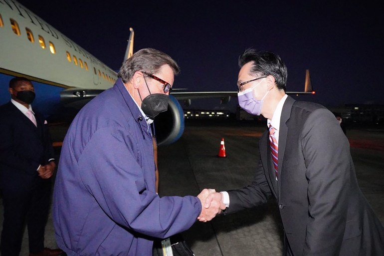 This handout picture taken and released by Taiwan's Ministry of Foreign Affairs (MOFA) on August 14, 2022 shows US Representative John Garamendi (L) shaking hands with Taiwanese diplomat Douglas Yu-tien Hsu