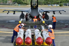 Taiwanese air force ground crew load US-made Harpoon AGM-84 anti-ship missiles in front of an F-16V fighter jet at Hualien Air Force base on August 17, 2022 [Sam Yeh/AFP]