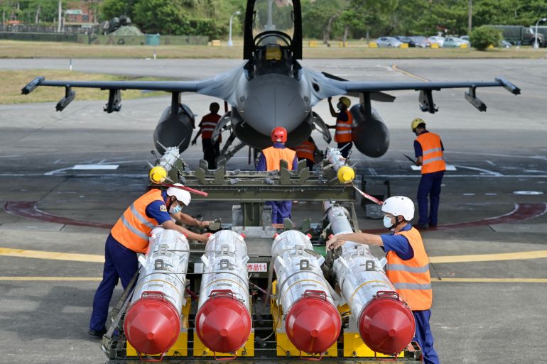 Taiwanese air force ground crew load US-made Harpoon AGM-84 anti-ship missiles in front of an F-16V fighter jet during a drill at Hualien Air Force base on August 17, 2022 [Sam Yeh/AFP]