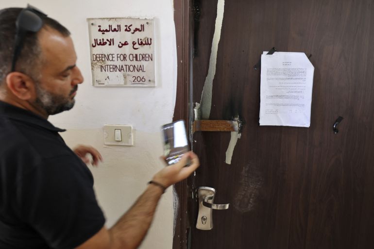 A picture shows the closed door of Palestinian NGO Defence for Children International after it was raided by Israeli forces in the West Bank city of Ramallah, on August 18, 2022.