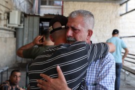 Relatives of 58-year-old Palestinian Salah Sawafta mourn his death outside a hospital morgue. Sawafta was killed during an Israeli army raid in the occupied West Bank town of Tubas on August 19, 2022 [Jaafar Ashtiyeh/AFP]