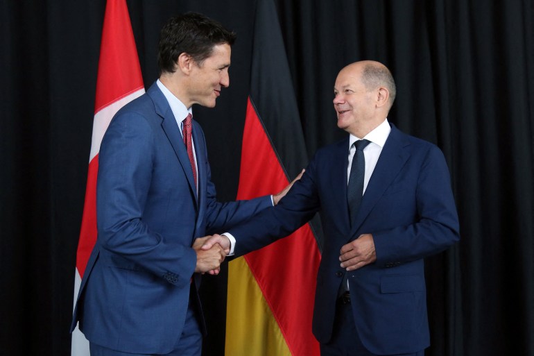 Canadian Prime Minister Justin Trudeau shakes hands with German Chancellor Olaf Scholz