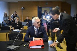 Editor-in-chief of Helsingin Sanomat Kaius Niemi (R) speaks with his lawyer Kai Kotiranta (L) ahead of the hearing for the Helsingin Sanomat Finnish Intelligence Research Center court case in Helsinki