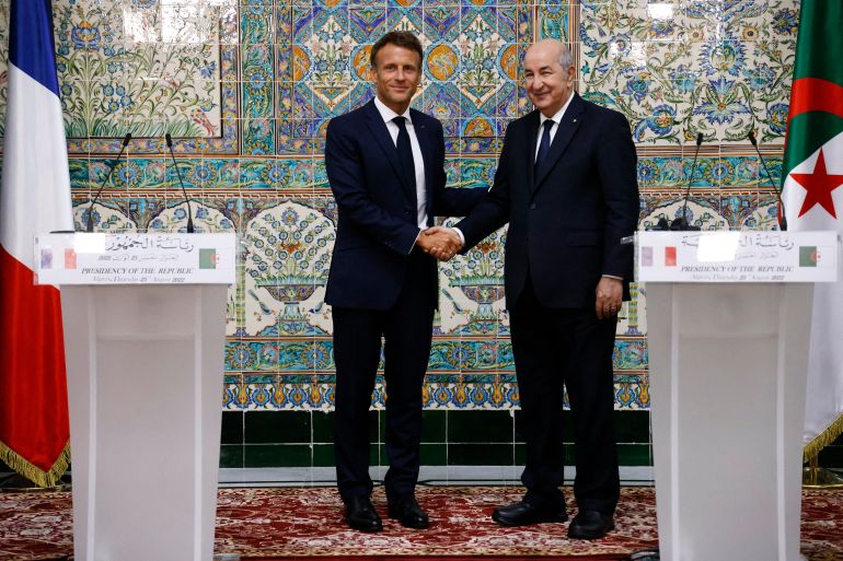 French President Emmanuel Macron and Algeria's President Abdelmadjid Tebboune shake hands as they attend a joint press conference at the presidential palace in Algiers, Algeria.