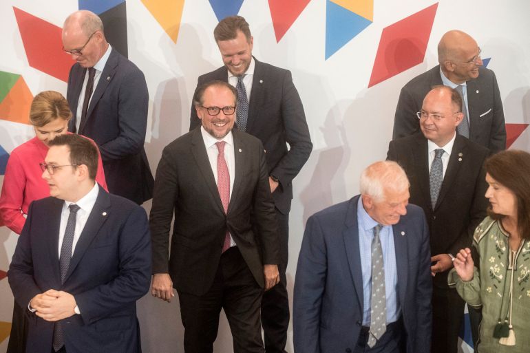 Austria's Foreign Minister Alexander Schallenberg (C) smiles after posing for a family photo with other participants of an informal meeting of EU Foreign Ministers (Gymnich) on August 31, 2022 in Prague, Czech Republic.