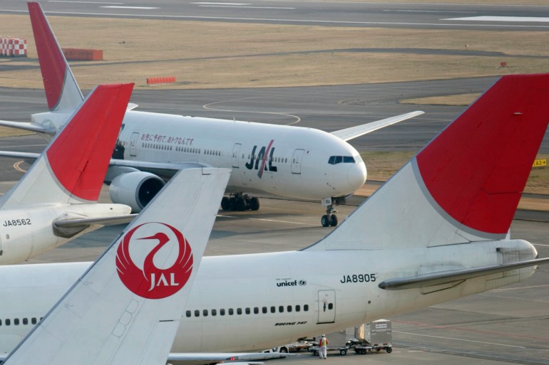 Planes on the tarmac of a Japanese airport.