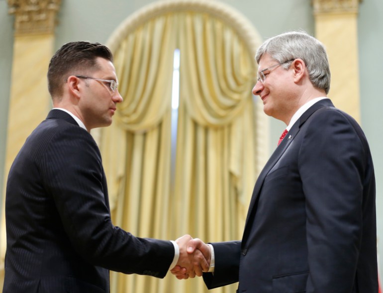 Pierre Poilievre (left) shakes hands with former Canadian Prime Minister Stephen Harper in 2013