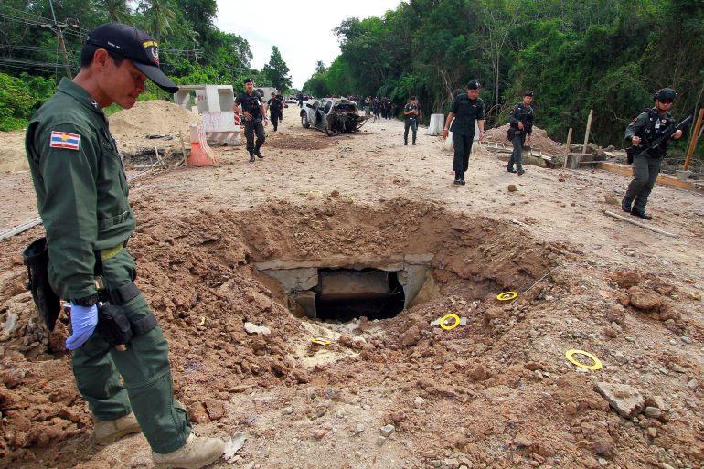 Military personnel search the site of a roadside bomb blast in the southern province of Pattani, Thailand, in 2017 [File: Surapan Boonthanom/Reuters]