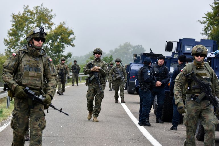 Members of the KFOR peacekeeping force patrol the area near the border crossing between Kosovo and Serbia in Jarinje, Kosovo, October 2, 2021. R