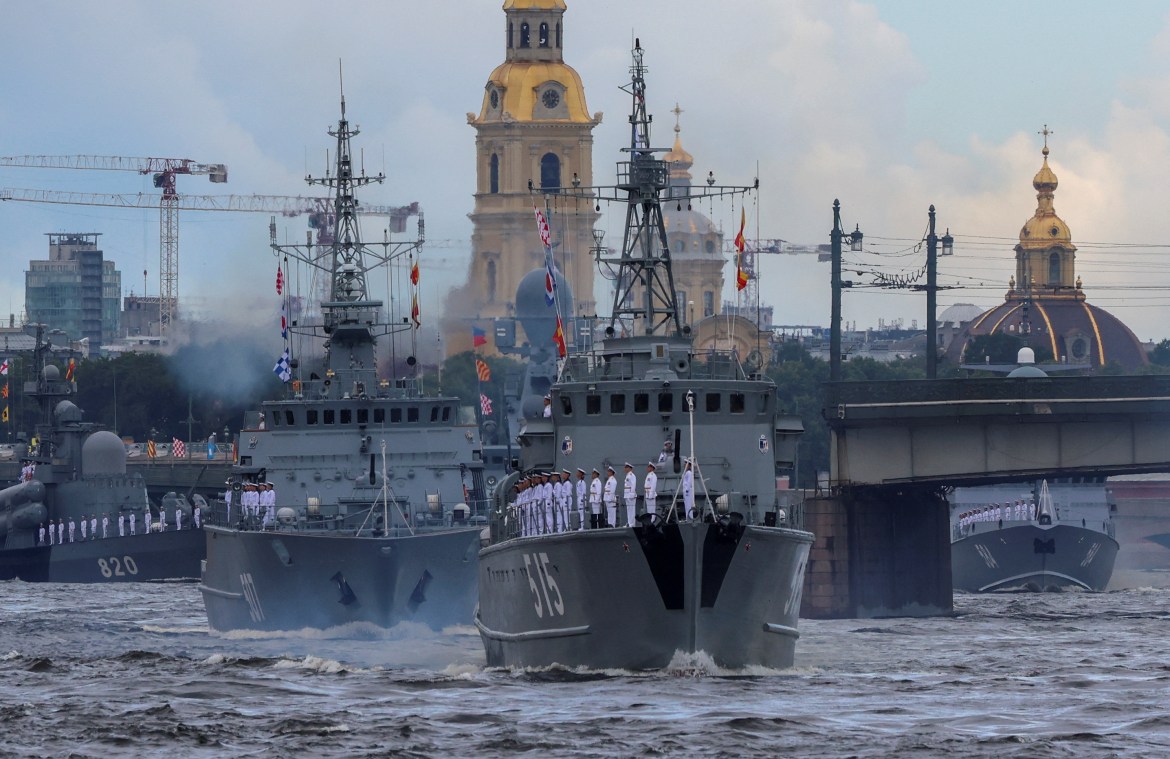 Russian warships, including minesweepers ships Pavel Khenov and Alexander Obukhov, sail during a parade marking Navy Day in Saint Petersburg
