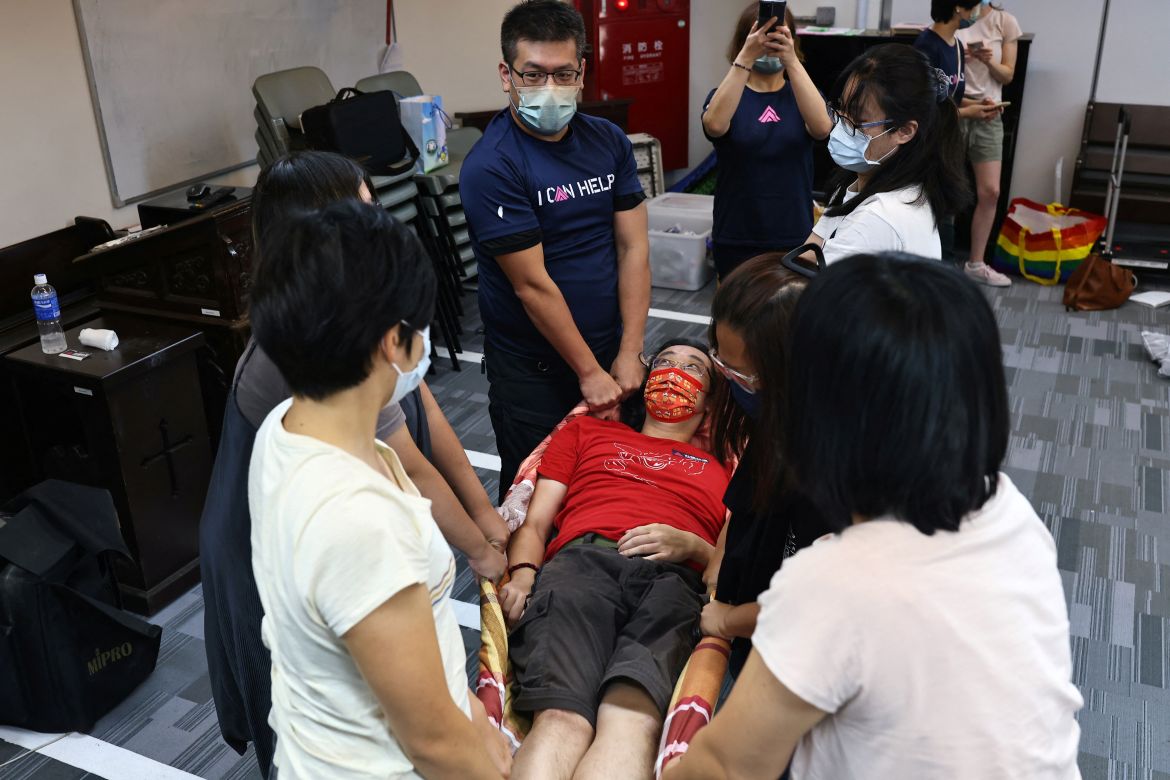 An instructor shows participants how to transport an injured person