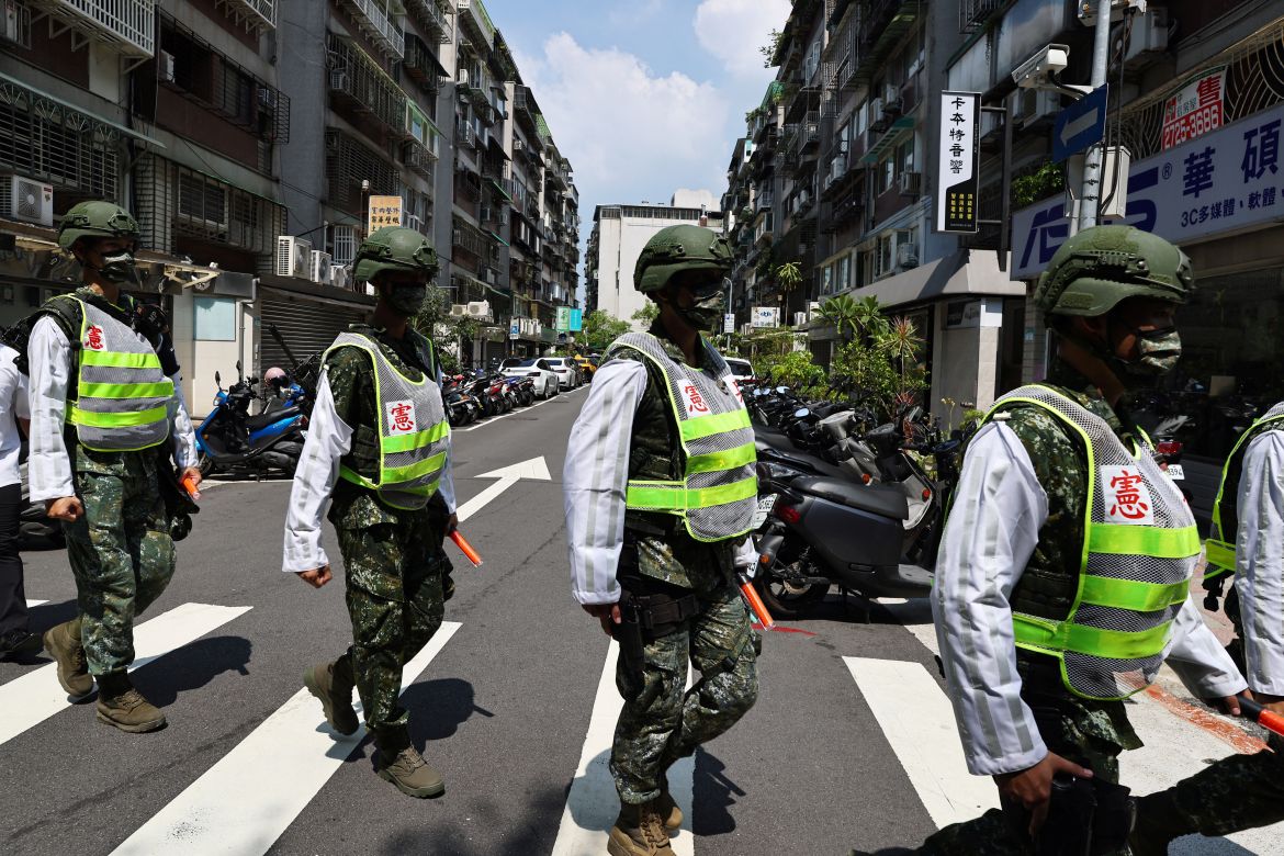 Military police officers get into position for a drill on how to guide citizens to safety in the event of an attack