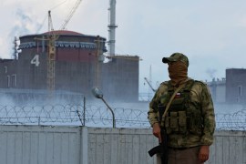 A Russian serviceman stands guard near the Zaporizhzhia Nuclear Power Plant.