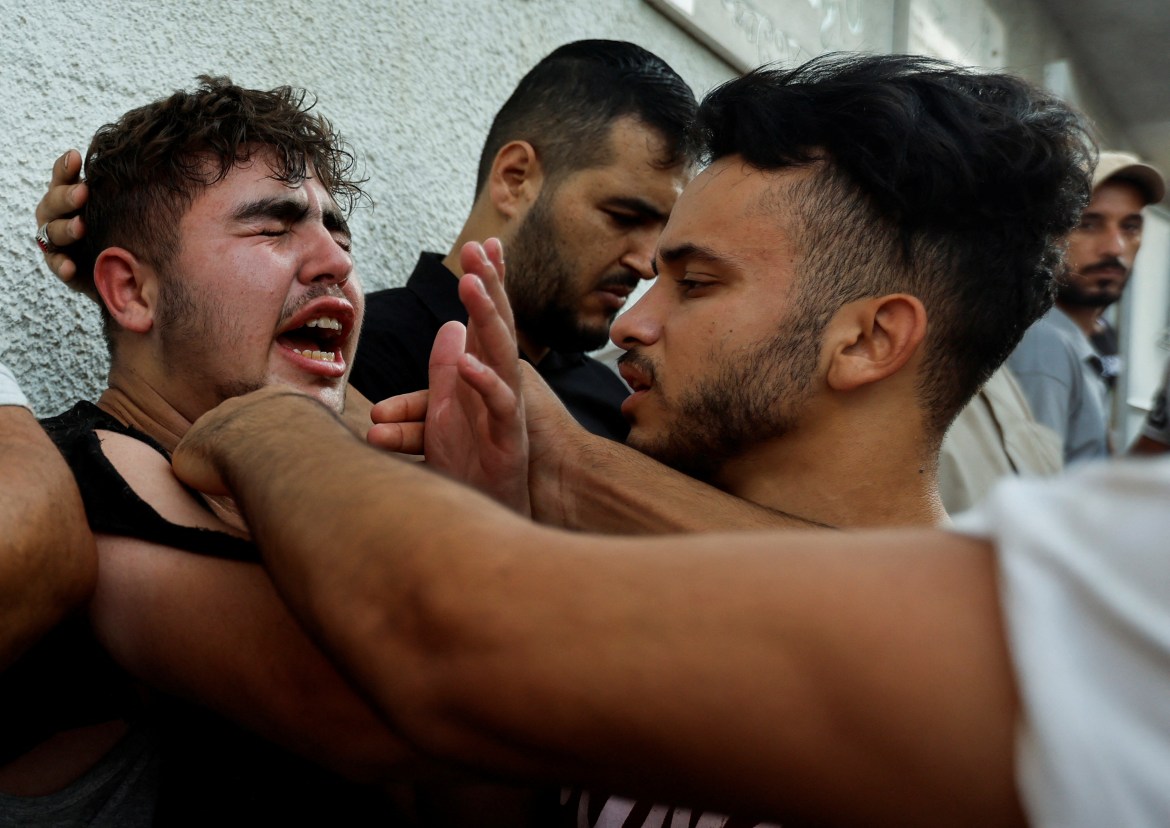 Palestinians react at a hospital following the strikes.