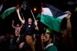 Palestinians celebrate on a street after a ceasefire was announced, in Gaza City, August 8, 2022 [Ibraheem Abu Mustafa/ Reuters]