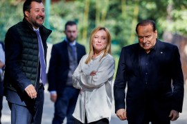 Berlusconi (R) reacts at the end of a meeting with Salvini (L) and Meloni (C) in Rome [File: Guglielmo Mangiapane/Reuters]