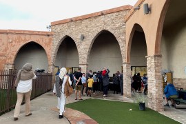 Participants in an interfaith memorial ceremony enter the New Mexico Islamic Center mosque to commemorate four murdered Muslim men, hours after police said they had arrested a prime suspect in the killings on August 9 in Albuquerque, New Mexico [Andrew Hay/Reuters]