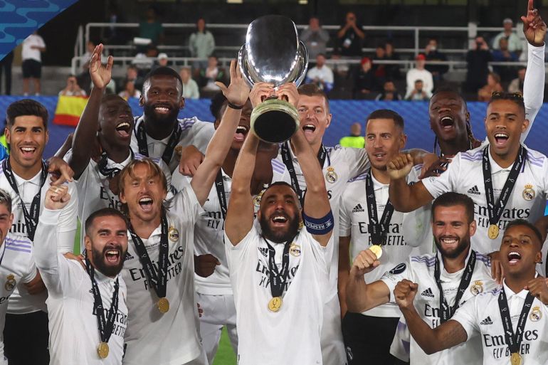 Real Madrid's Karim Benzema lifts the trophy as he celebrates with teammates after winning the European Super Cup