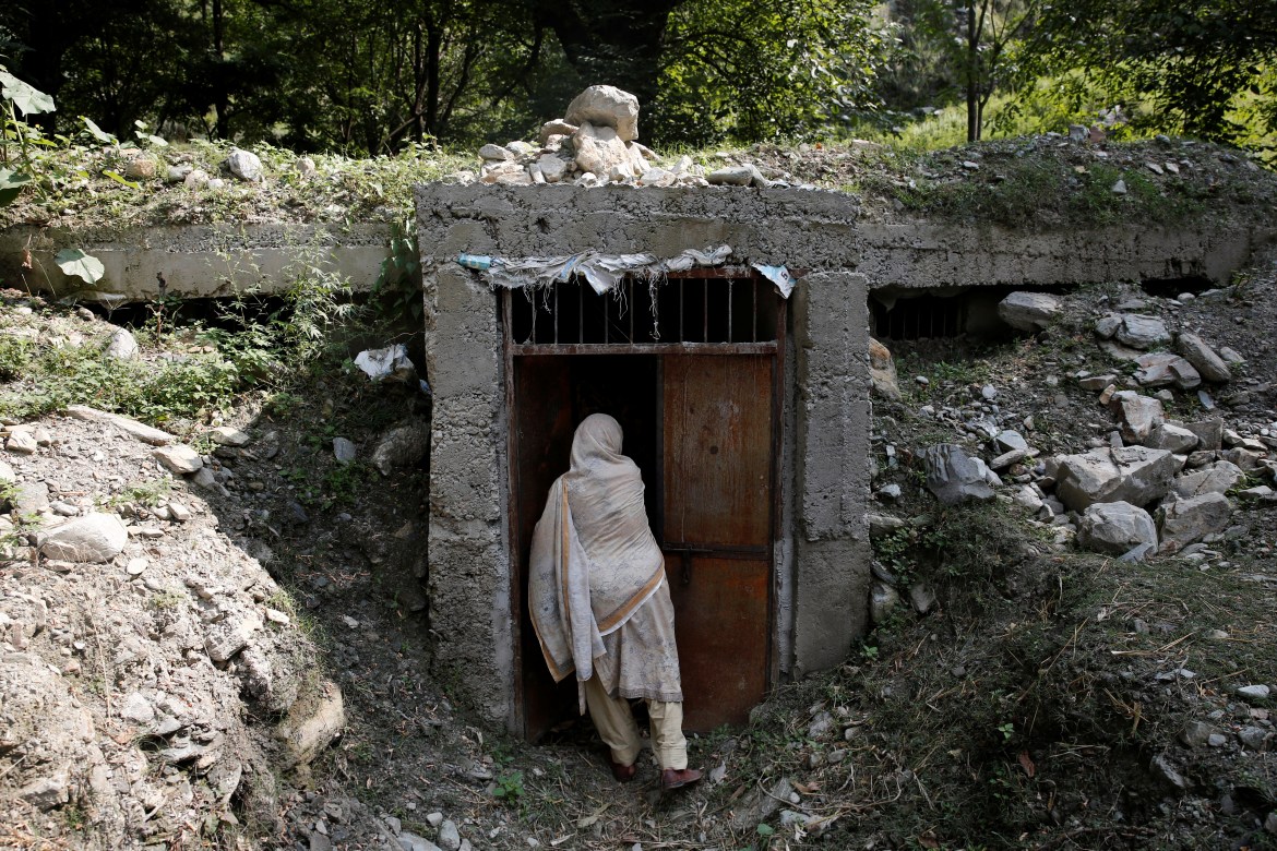A woman opens the door of a bunker