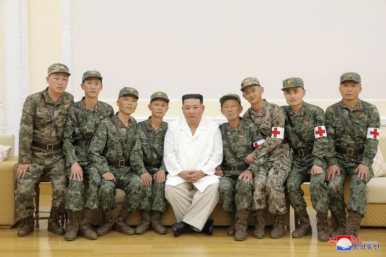 North Korea's leader Kim Jong Un poses for a photo with Korean People's Army medics during a meeting to recognise their contributions in fighting the COVID-19 pandemic in Pyongyang, North Korea