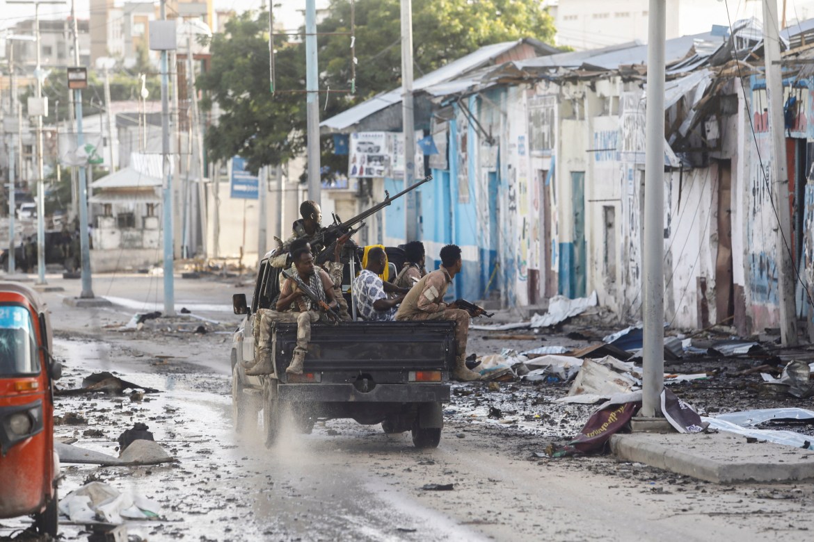 Somali security officers drive past a section of Hotel Hayat.