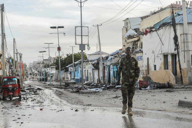 A Somali security officer walks past a section of Hotel Hayat during siege