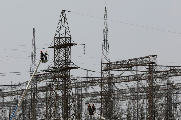 Employees work on electricity networks near the Zaporizhzhia Nuclear Power Plant.