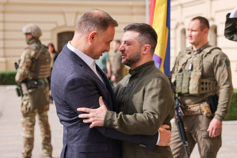 Ukraine's President Volodymyr Zelenskiy and Poland's President Andrzej Duda hug each other as they meet, amid Russia's attack on Ukraine, in Kyiv