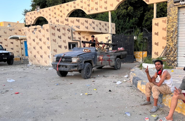 Fighters loyal to the head of Libya's Government of National Unity (GNU) and Prime Minister Abdulhamid al-Dbeibah, gather in the street amid clashes in Tripoli