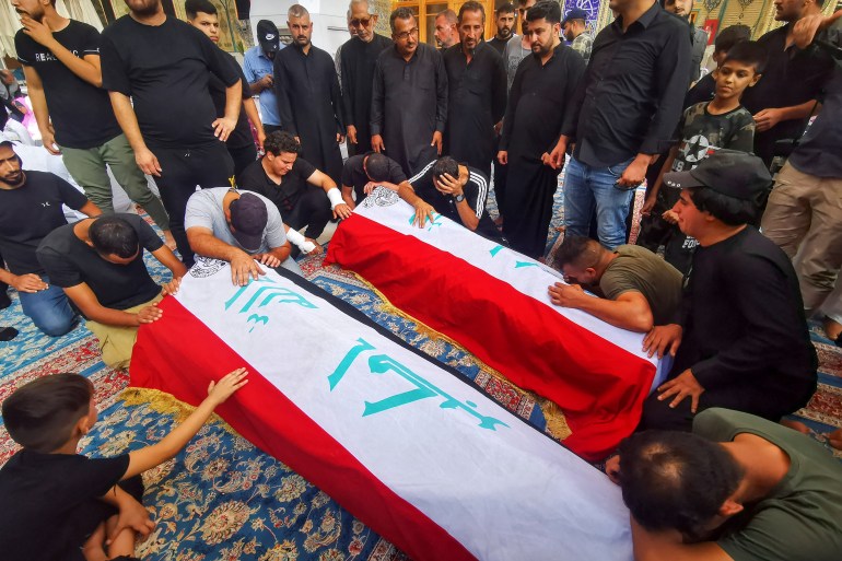 Mourners pray in front of the coffins of supporters of Iraqi populist leader Moqtada al-Sadr, who were killed during clashes in Baghdad, during their funeral in Najaf, Iraq August 30, 2022