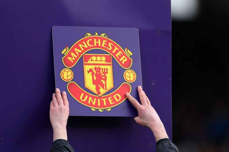 The Manchester United club badge is put up on the board during the Premier League match between Fulham FC and Manchester United at Craven Cottage in London, UK.