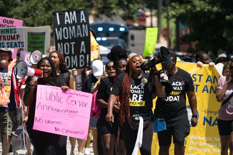 Protestors march and chant in Downtown Atlanta, in opposition to Georgia's new abortion law