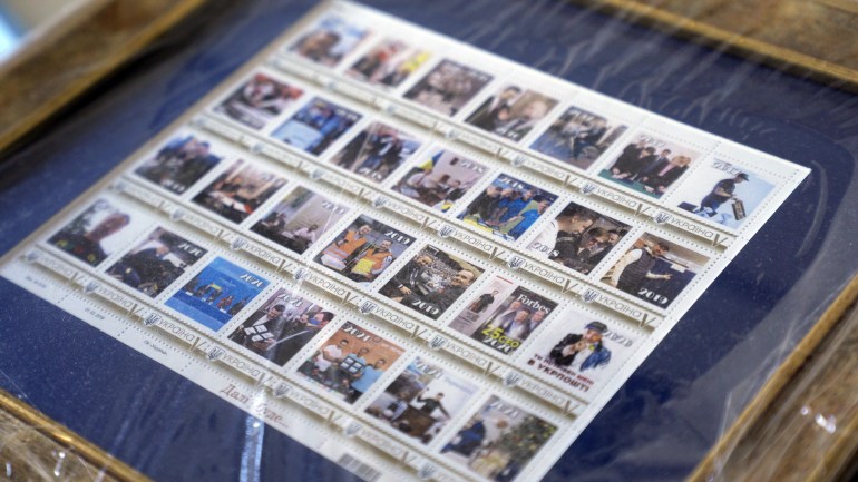 A collection of personalized stamps inside Igor Smelyansky’s office [Shelby Wilder/Al Jazeera]