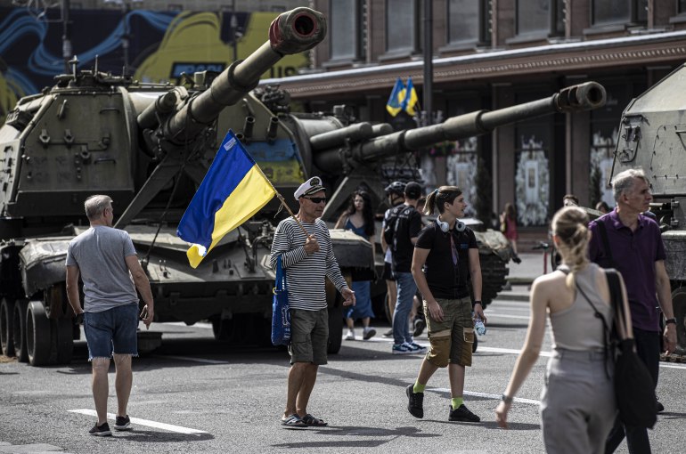 People are seen walking through an exhibition of destroyed Russian military vehicles in Kyiv