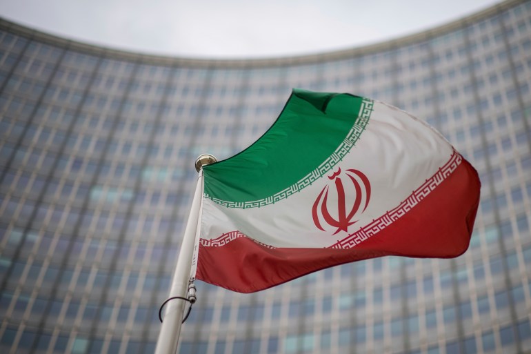 A national flag of Iran in front of the building of the International Atomic Energy Agency, IAEA, in Vienna, Austria