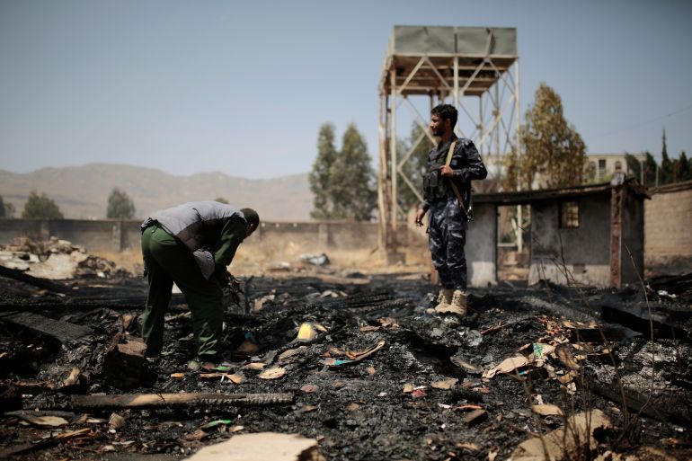 Yemeni police inspect a site of Saudi-led airstrikes targeting two houses in Sanaa, Yemen