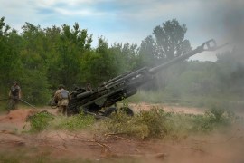 Ukrainian soldiers fire at Russian positions from a US-supplied M777 howitzer in Ukraine&#39;s eastern Donetsk region, June 18, 2022 [File: Efrem Lukatsky/AP Photo]