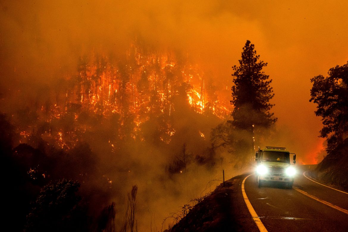 A firetruck drives along California Highway 96 as the McKinney Fire burns in Klamath National Forest