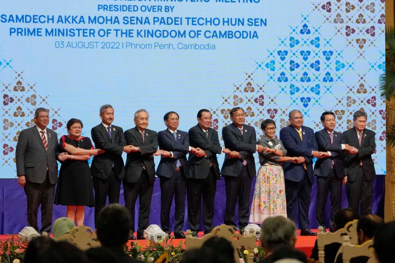 Asean foreign ministers standing on stage at their meeting in Phnom Penh