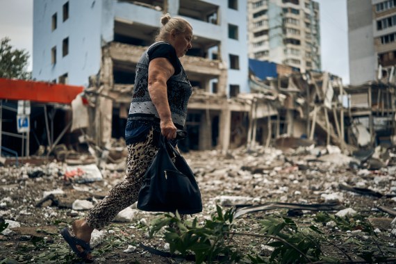 A woman walks by destroyed buildings after the Russian shelling in Mykolaiv, Ukraine.