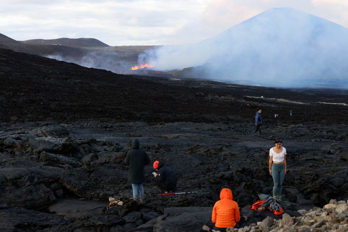 People walk to get a view of the eruptions on Fagradalsfjall volcano