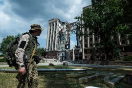 Ukrainian serviceman stands in front of headquarters of the Mykolaiv Regional Military Administration