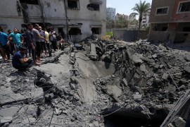 Residents inspect the rubble of a destroyed residential building hit by Israeli air attacks in Gaza [Adel Hana/AP Photo]