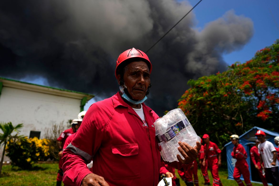 Members of the Cuban Red Cross prepare to be transported to the Matanzas Supertanker Base, where firefighters work to quell a blaze which began during a thunderstorm the night before, in Matazanas, Cuba