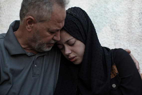 Relatives of Ismail Dweik, who was killed in an Israeli airstrike, mourn before his funeral, outside a hospital in Rafah, in the southern Gaza Strip, Sunday, Aug. 7, 2022.